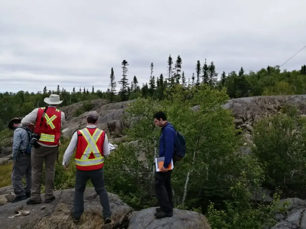 Исследователь на обнажении ультрамафических пород Abitibi-комплекса, Пайк-Хилл. Видна характерная текстура породы с включениями оливина